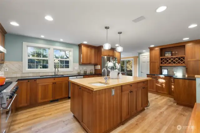 The finishes are so beautifully pulled together - the cherry cabinets - the soapstone counters and a butcher block island.