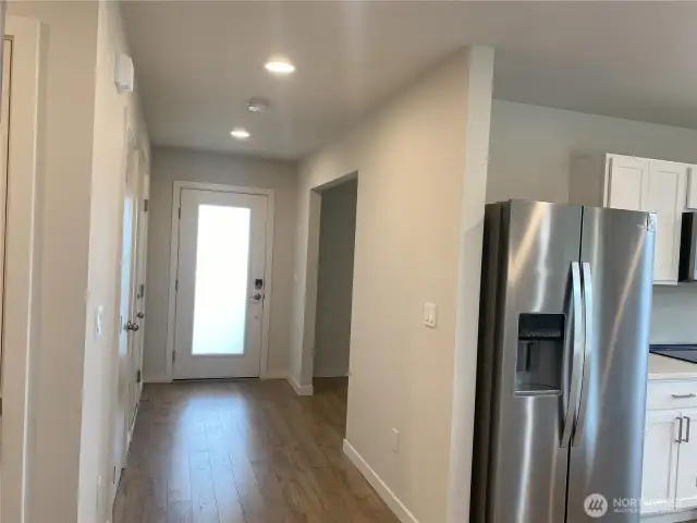Front door and garage access. Coat Closet.