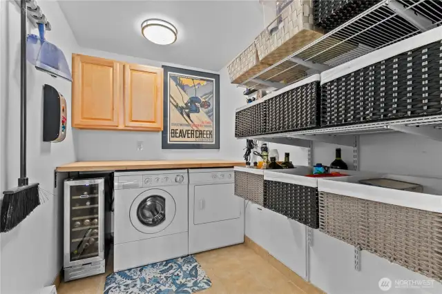 Off-kitchen laundry room with wine fridge