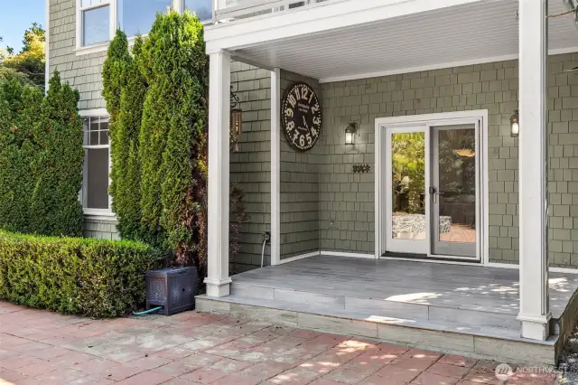 Covered Porch and BBQ area opens from home to Spectacular low maintenance paved garden areas