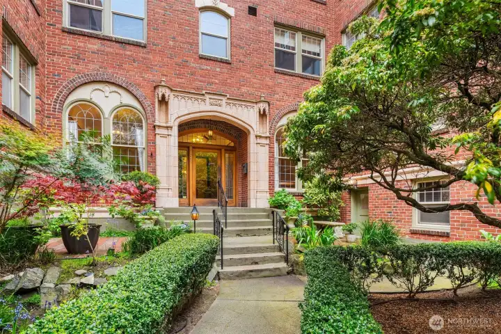 Welcome to Queen's Court, a well-maintained 1930-built condo building positioned on a quiet, tree-lined street one block from Climate Pledge Arena and Seattle Center in the heart of Lower Queen Anne.