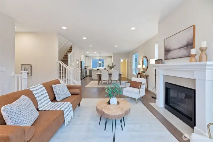Oversized elegant great room with cozy gas fireplace leading to the welcoming dining room