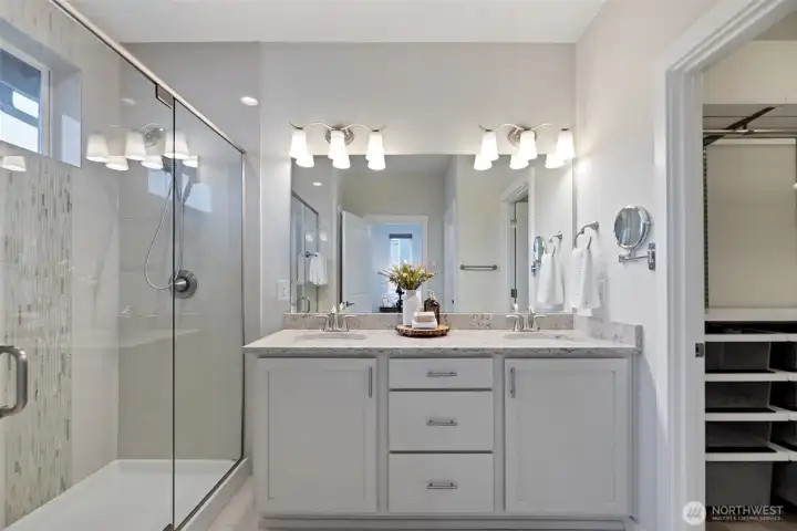 Well designed master bath with over-sized shower, double sink with plenty of storage with walk-in closet