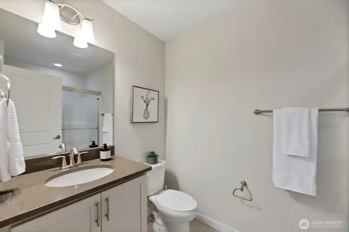 Main level ensuite/guest bathroom with shower