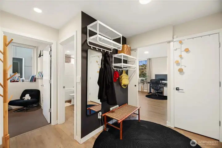 Main entrance level featuring a welcoming foyer, mudroom storage, coat closet, and two bedrooms.