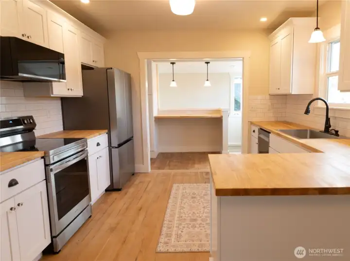 Bright, modern kitchen with white shaker cabinetry and subway tile.