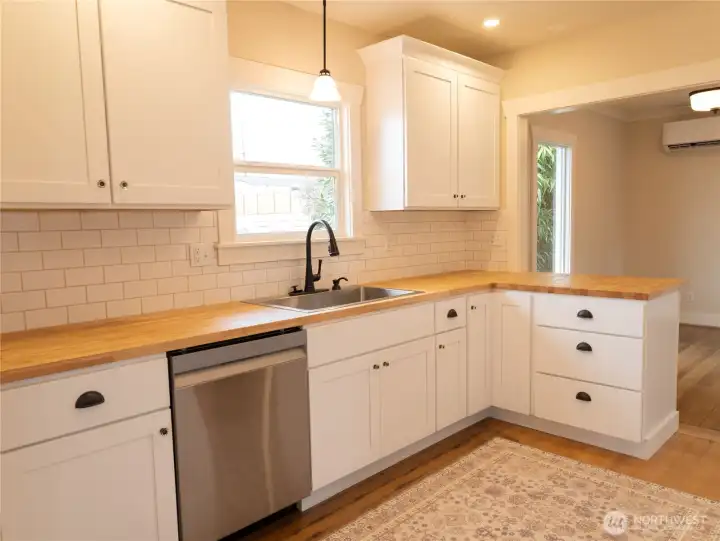 The well-designed kitchen area offers an open and inviting feel creating a seamless flow between the cooking and dining spaces.