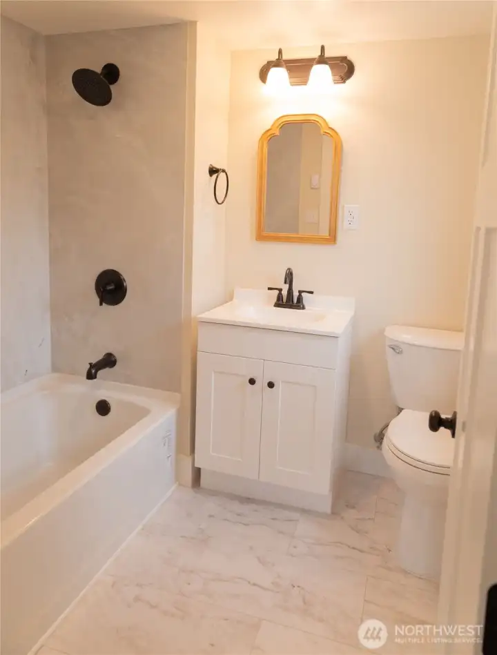 Beautifully updated bathroom featuring stylish fixtures and finishes that create a fresh, polished, and inviting space.