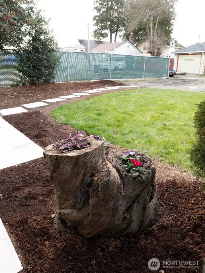 Fresh, low-maintenance landscaping off the patio creates an inviting outdoor space that’s easy to enjoy and ready for relaxing or entertaining.