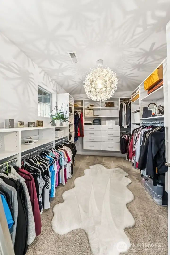 One of two walk in closet's in Primary with built in closet system