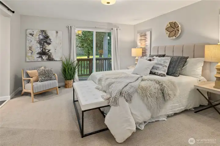 Spacious primary suite with slider to a small deck.