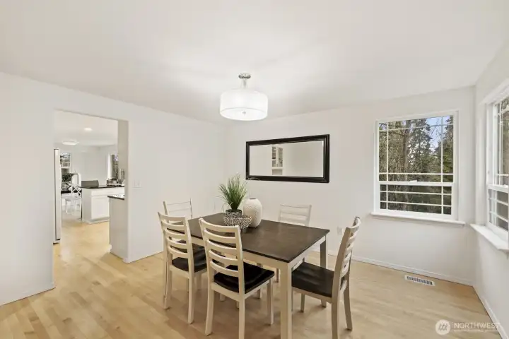 Formal dining room with views into the park-like backyard.