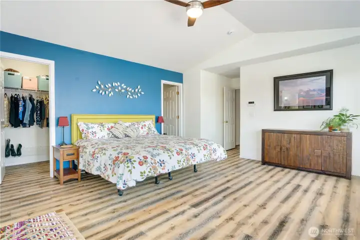 Expansive Primary Bedroom with a walk through closet behind the bed