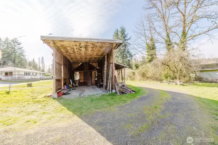 31'  X  14' covered parking for R/V.   Fruit trees and garden area nearby.