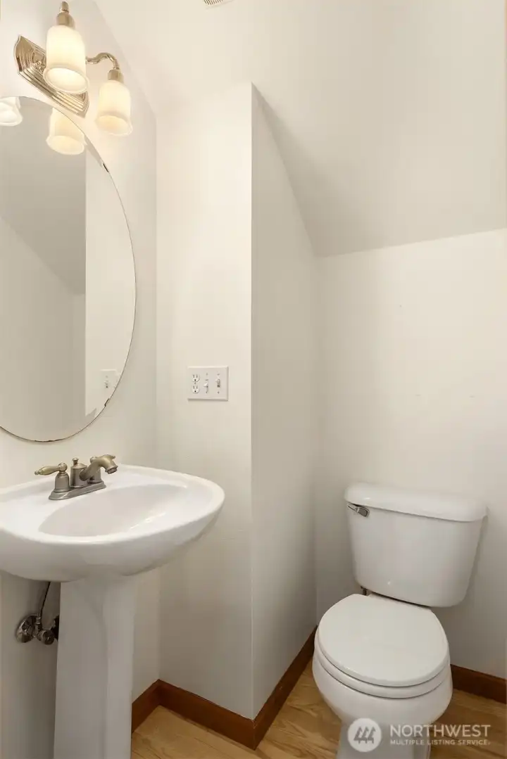 The powder room is situated privately from the main living areas and kitchen on the first floor. The powder room is situated privately from the main living areas and kitchen on the first floor.