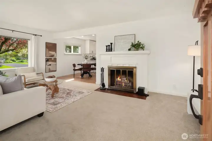 Living room with wood fireplace (fire added for visual, buyer to verify functionality).