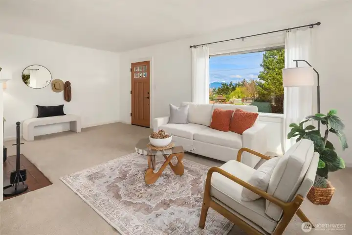 Spacious living room with large windows providing ample natural light throughout.