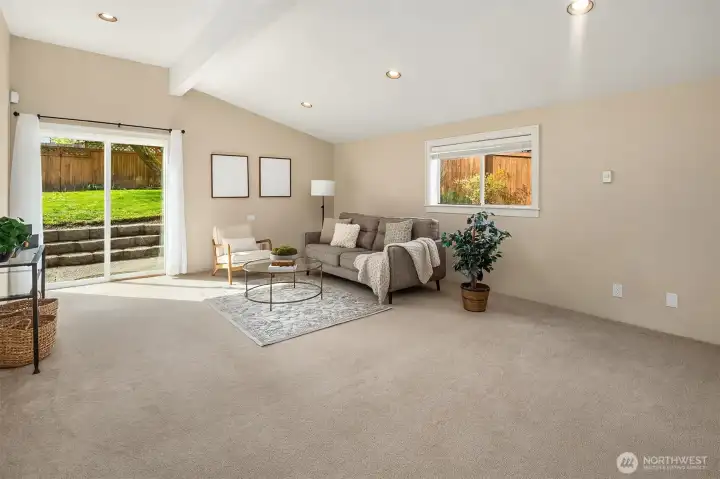 Living room with sliding glass doors leading to back yard & patio.
