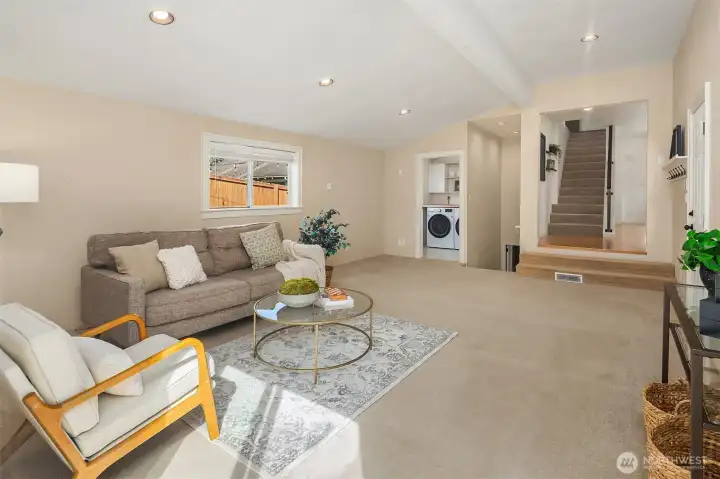Living room with access to main level, upstairs, basement and laundry room.