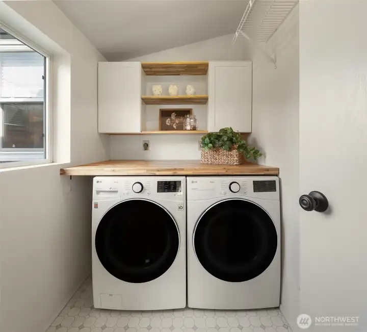 Laundry room with ample storage.