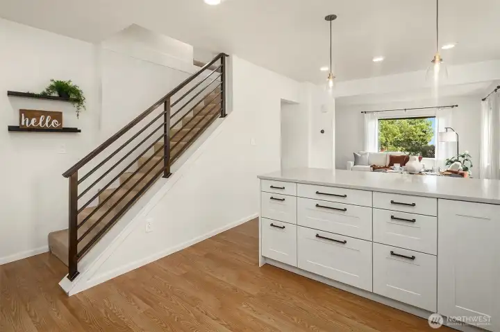 Kitchen flowing seamlessly into living space & upstairs.