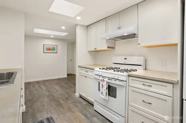 Remodeled kitchen with a gas range, laminate floors, new soft close and slide out cabinets and skylight.