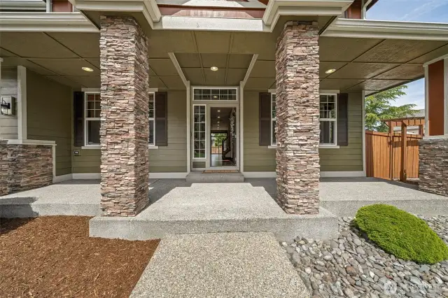 Enjoy greeting your guests on this stunning & inviting covered front porch.