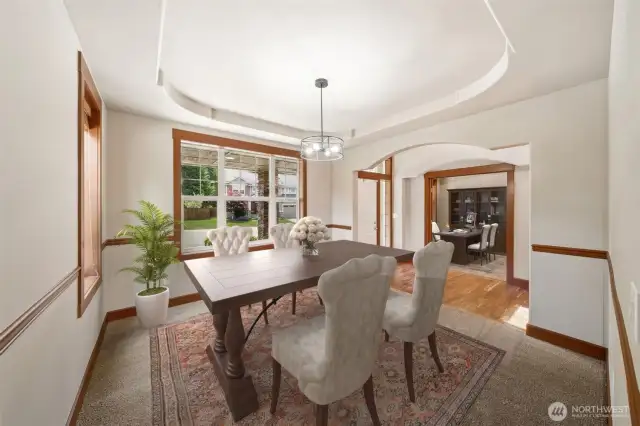 The Dining Room is open & bright featuring beautiful wood trim and coffered ceiling. (Virtual staging).