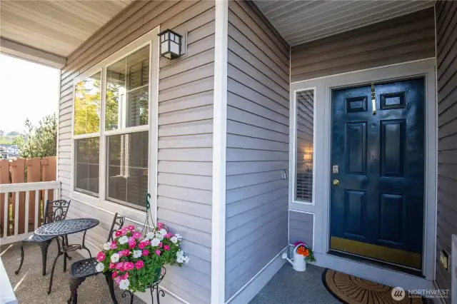 The front entry greets you with covered porch and entry door.