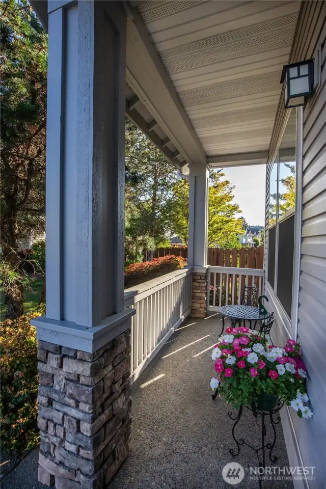 The covered porch at the front entry is inviting, a nice place to sit and relax.