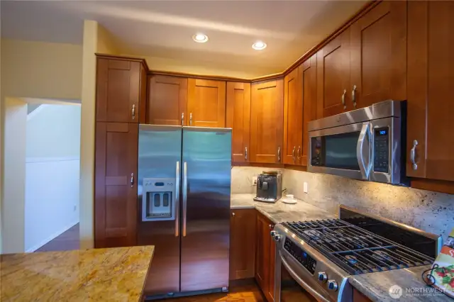 Meal preparation is a delight to any chef in this kitchen with lots of custom cabinet space and the work island, gas stove and oven and beautiful countertops.