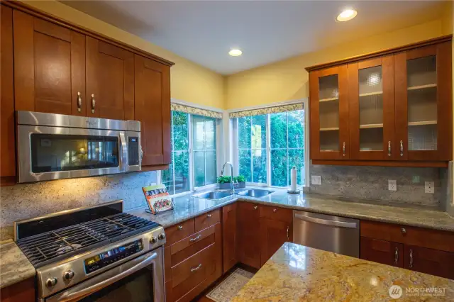 The corner windows provide so much natural light, overlooking the peaceful back yard. Imagine cooking in this dreamy kitchen.