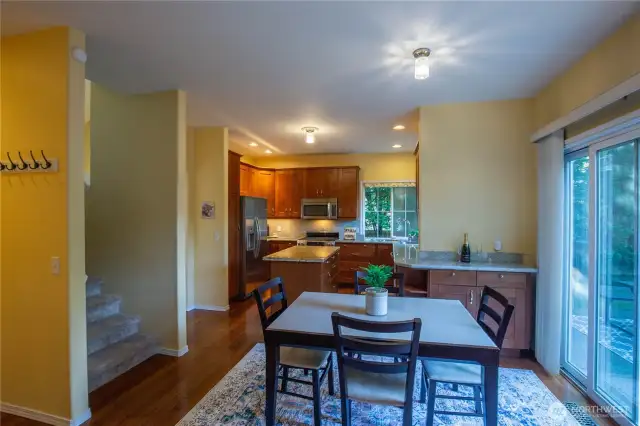 Looking from the family room to the kitchen, you see the slider out to the large patio and fenced back yard.