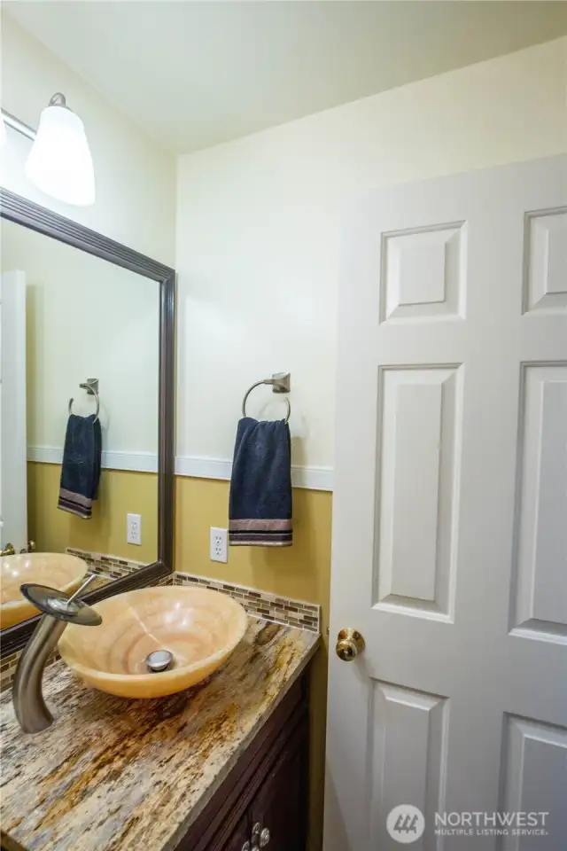 The updated guest half bathroom is off the family room in the hall leading to the garage entry door.