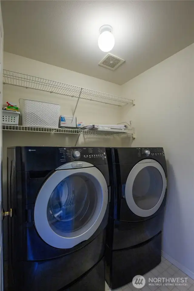 The laundry room is located on the upper floor conveniently near the bedrooms, and the washer and dryer are included in the sale.