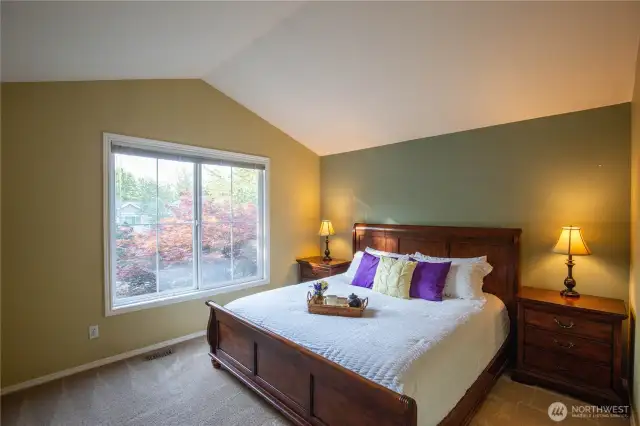 The dreamy primary ensuite is split from the other bedrooms, has vaulted ceilings and a large window flooding it with natural light.