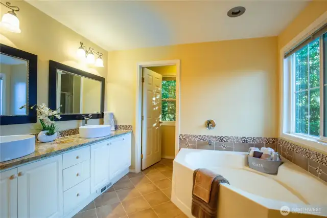 The luxurious updated 5-piece primary bathroom has dual sink vanity, large soaker tub for unwinding and soaking your cares away, and additional separate room with shower and lavatory.