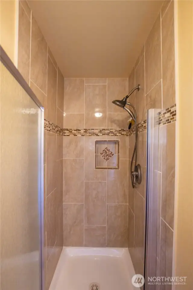 The updated and refreshed shower is in its own room with the toilet for privacy.