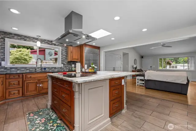Chef's kitchen featuring custom cabinetry and a glorious granite slab island! High-end Miele, Subzero & Thermador appliances all stay