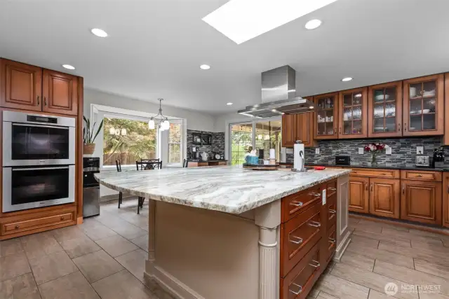 Chef's kitchen featuring custom cabinetry and a glorious granite slab island! High-end Miele, Subzero & Thermador appliances all stay