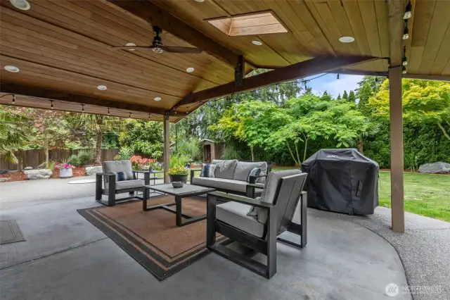 Your private backyard oasis awaits. Enjoy a huge covered patio for entertaining and stunning landscaping with built-in fire pit, water feature, and a ton of lush native and non-native plants! Two generously sized outbuildings provide ample additional storage