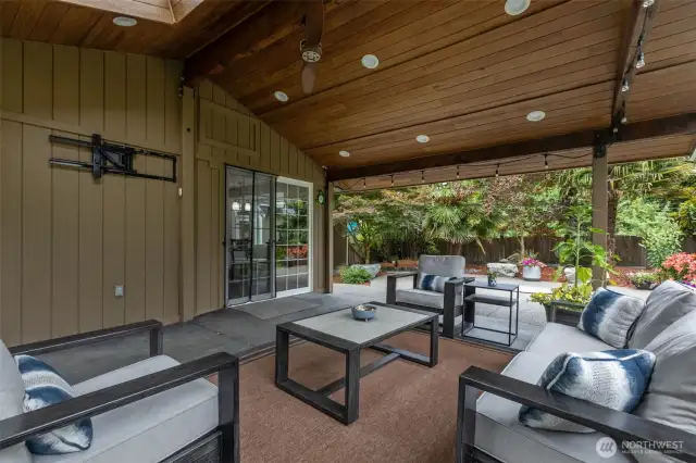Your private backyard oasis awaits. Enjoy a huge covered patio for entertaining and stunning landscaping with built-in fire pit, water feature, and a ton of lush native and non-native plants! Two generously sized outbuildings provide ample additional storage