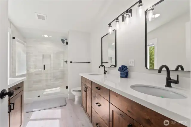 Upper level bath with double sinks and beautiful tiled shower