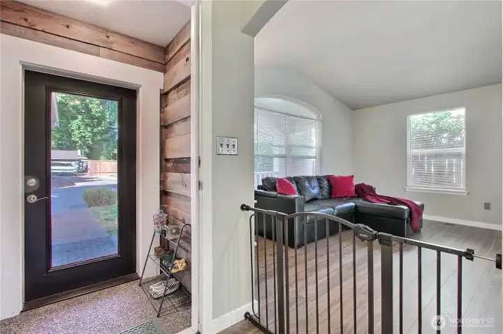 Home has a charming covered entryway. A great place to take off the rainboots.