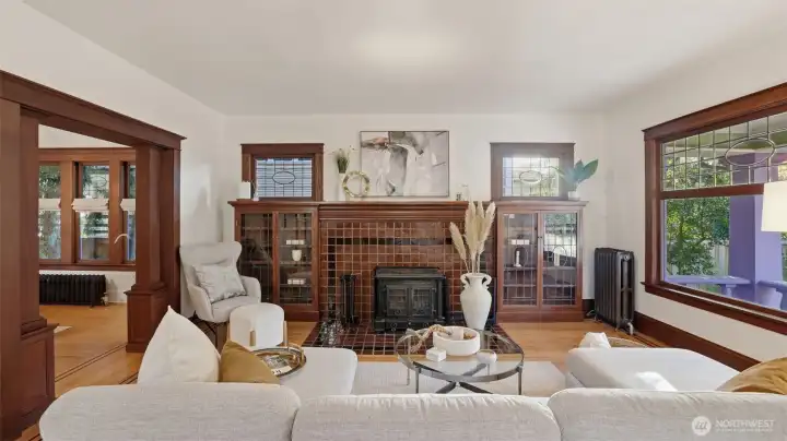 Living room with signature oval accented leaded glass windows & built-ins