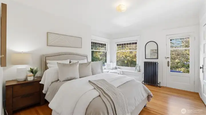 1 of 4 upstairs bedrooms. Southwest facing with the sweetest window seat, walk in closet & deck shared with the adjacent bedroom.