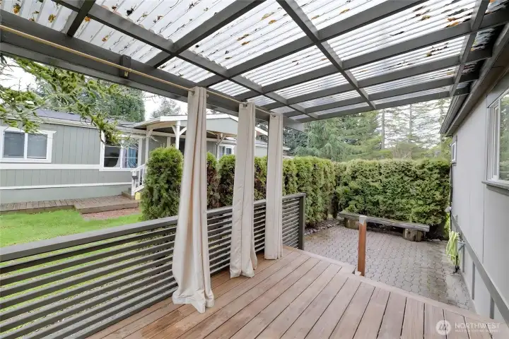 Expansive back deck ideal for entertaining, complemented by an adjacent patio area
