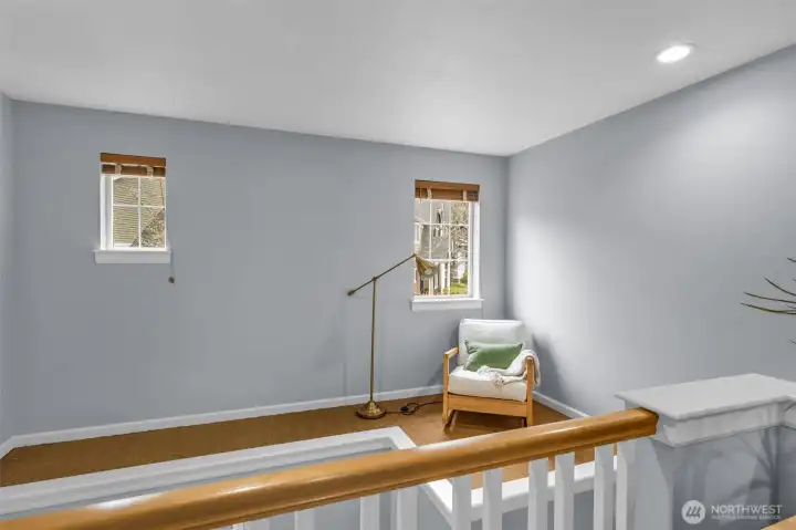 The charming nook is accessible by a custom-made ladder. The current owner used this as a reading nook with some low bookshelves along the wall.