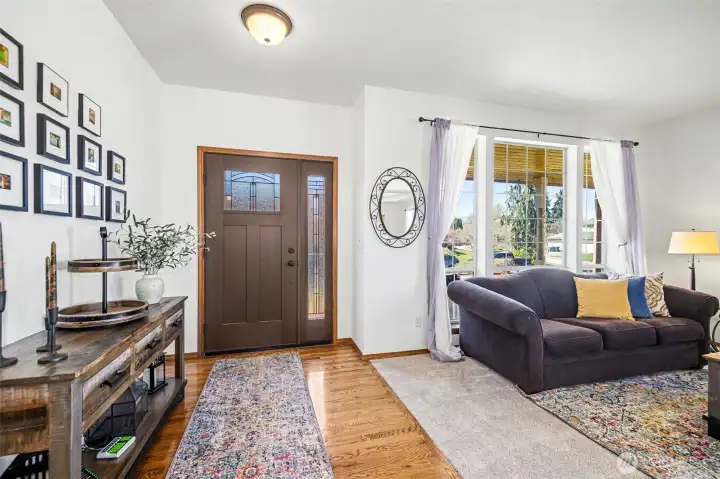 Open entrance with gorgeous hardwood floors and new carpets