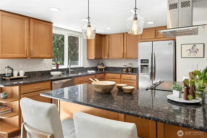 The updated kitchen has a breakfast bar and solid granite counters.